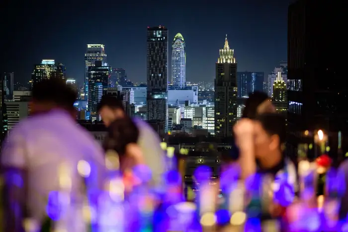 A blurred crowd and glowing bottles frame the sparkling skyline at Above Eleven—one of the most vibrant Bangkok rooftop bars for solo travellers who enjoy city views with a touch of mystery. Featured on The Road to Timbuktu, this Sukhumvit hotspot blends urban edge with sky-high charm.