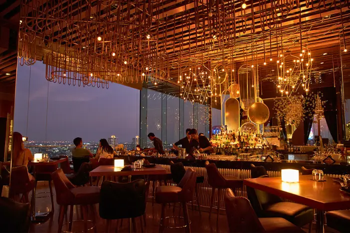 Inside SEEN Rooftop Bar’s glowing cocktail lounge, where golden lights and skyline views make it one of the most classy rooftop bars Bangkok has to offer. Featured on The Road to Timbuktu, it’s a go-to for solo travellers over 50 who prefer plush chairs, good lighting, and a cocktail that doesn’t come in a bucket.