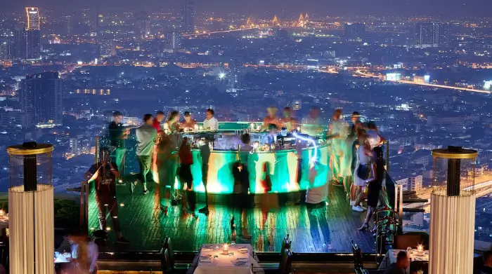 A glowing circular bar perched high above the city lights, capturing the vibrant energy of one of the top sky bars Bangkok has to offer. This buzzing rooftop spot, featured on The Road to Timbuktu, is ideal for mature solo travellers seeking classy rooftop drinks with a view.