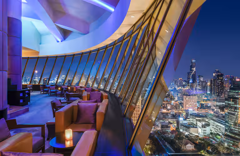 The moody, elegant interior of Three Sixty Jazz Lounge, where live music and river views set the tone for refined solo travel over 50 Bangkok style. Featured on The Road to Timbuktu, this is where the martinis are stirred, the saxophones croon, and no one asks why you're dining alone—because honestly, you’re doing it better.
