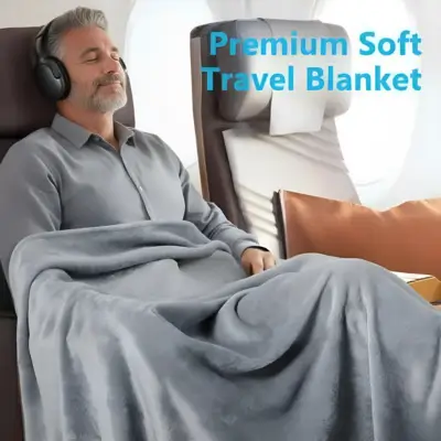 Mature solo traveller over 50 resting on a plane with a premium soft travel blanket, showing how to stay warm and comfortable on long journeys. Featured in Best Vacations for Single Guys Over 50 on The Road to Timbuktu.